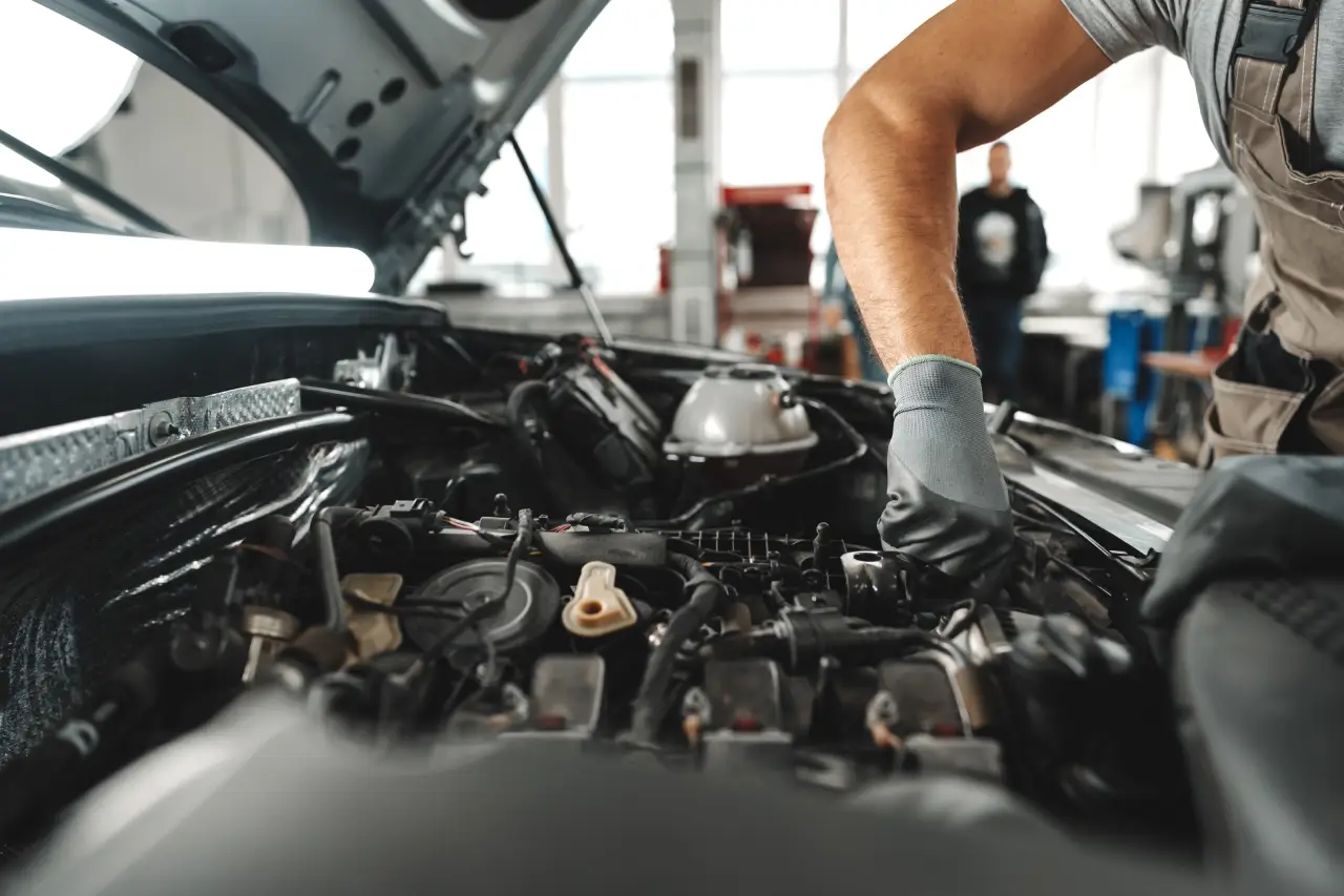 ESS technician working on a car engine in the Dallas shop