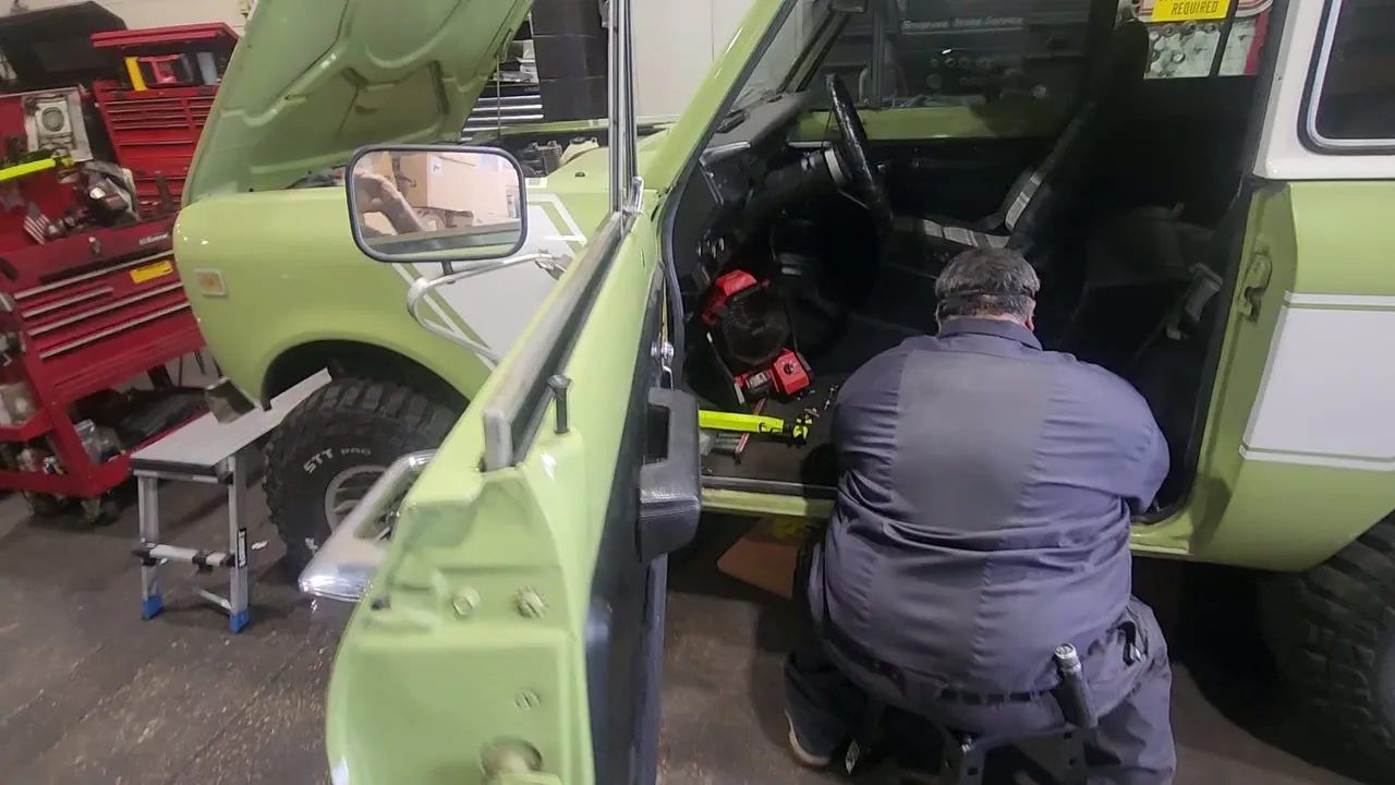 An ESS technician working on a classic two tone 4x4 inside the shop